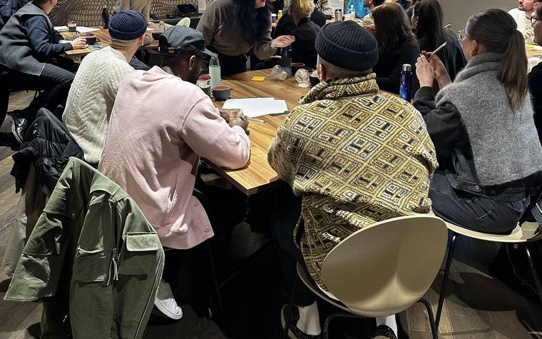 A team session in progress around a workshop table